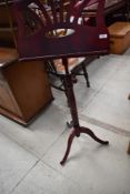A reproduction rosewood effect music stand