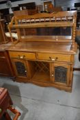 A vintage colonial style sideboard having mirror and shelf back, width approx. 124cm