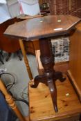 A Victorian mahogany occasional table having turned pedestal base , triple legs and possibly later