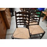 A set of six traditional rush seated ladder back chairs