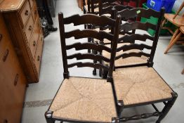 A set of six traditional rush seated ladder back chairs