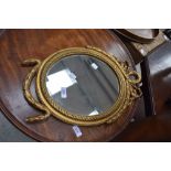 A vintage reproduction gilt plaster wall mirror of smal proportions, having swag decoration, bears