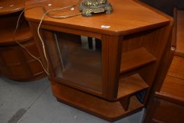 A mid century style teak effect cabinet with glass front door by Nathan