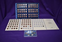 A Lincoln Cents part set 1941 onwards in two US Cent albums along with a set of 6 State Quarters,