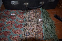 An antique shawl having fringed edging and paisley pattern, some damage and wear.