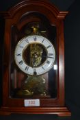 A wooden cased chiming mantel clock.