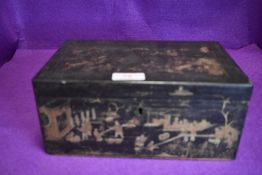 An oriental lacquered tea caddy having gilt detailing.AF