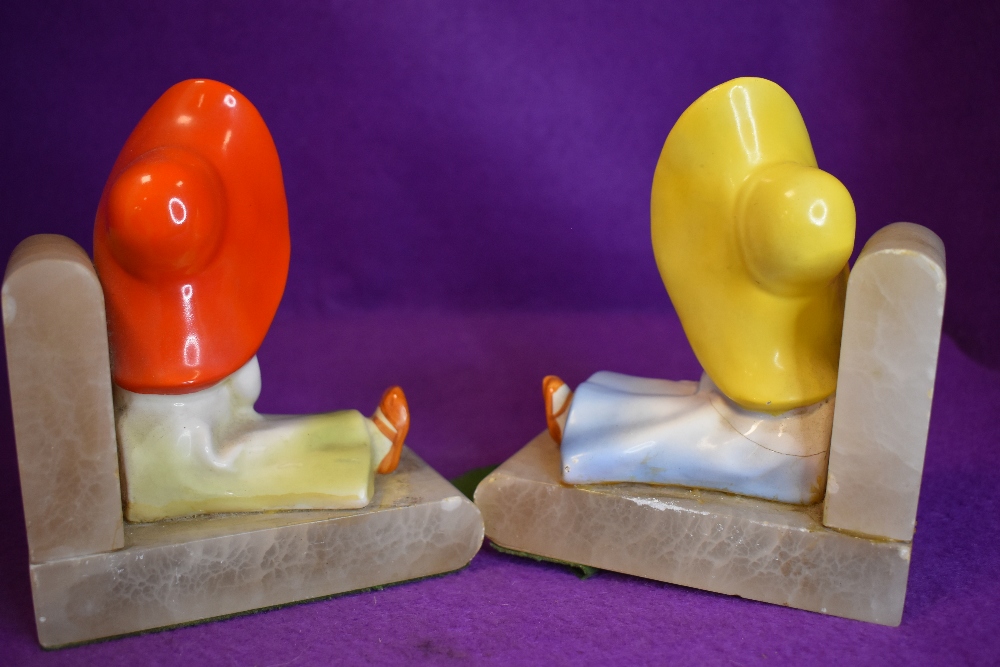 A pair of art deco book ends depicting young girls in sunhats, one holding camera the other a rose. - Image 2 of 2