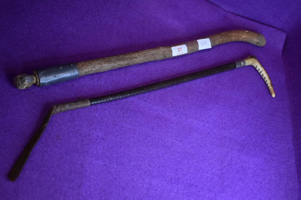 An antique horn handled leather bound riding crop and a primitive home made shillelagh.