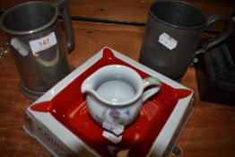 Two pewter pint mugs one signed PPW 1931