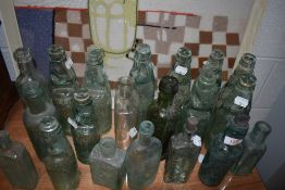 A good selection of antique and later vintage glass advertising bottles beer and medical examples