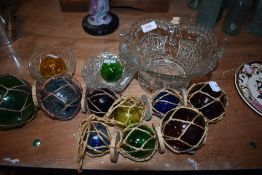 A selection of colour glass fishing floats and similar glass
