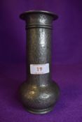 A Tuderic pewter vase having hammered effect.