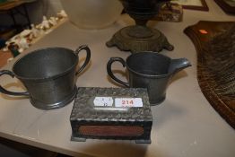 A selection of pewter wares including creamer, loving cup and large matchbox holder.