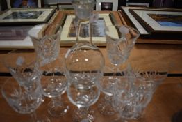 A selection of clear cut crystal wine glasses and similar slender styled decanter