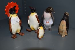 A family of three Beswick penguins, also one in the Copenhagen style and another composed from