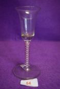 A wine glass having bell shaped bowl and multi twist stem.