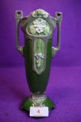 An Eichwald twin handled vase having strong art nouveau styling with green ground and grey accents