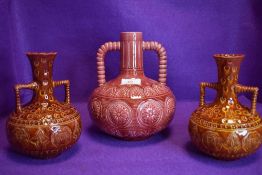 Three Bermantofts pottery handled vases,two in Terracotta and another in pink, around early 1900s.