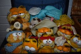 A suitcase containing an assortment of Garfield toys.