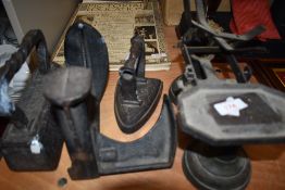 A selection of cast iron hardware including shoe last stove iron and scale set