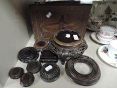 A selection of Chinese and Japanese hard wood carved ceramic stands and similar small oak foot