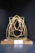 An art nouveau letter rack in brass and copper.