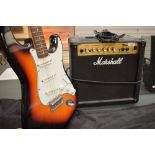 An Encore electric guitar (Fender Stratocaster style) and a Marshall MG15CD practice amplifier