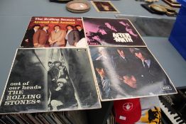 A box of approximately fifty albums including four early Rolling Stones albums , three of which