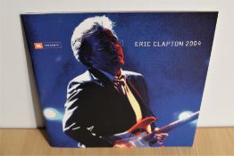 An 2004 Eric Clapton tour programme with an exclusive compact disc - both the disc and programme are