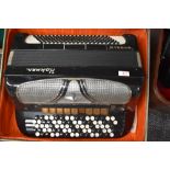A vintage Hohner Riviera IV button accordion, in vintage lined card case