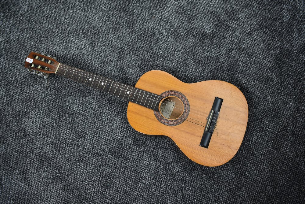 A vintage Encore by John Hornby Skewes student guitar, model ENC36N, soft case and couple of music