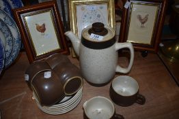 A partial Denby coffee set including cups and saucers,coffee pot and creamer.