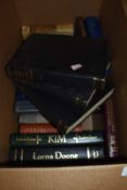 A box of books including novels and more.