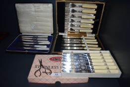 A selection of vintage flat ware including boxed Mother of pearl handled knives and fish servers.
