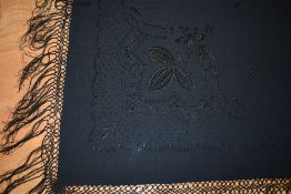 An antique Victorian black shawl with extensive and intricate beading, embroidery and deep fringe to