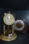 An art deco mantle clock and similar anniversary domed clock.