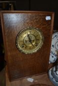 A clock mounted into a vintage speaker casing.