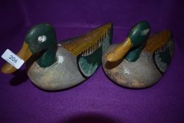 Two genuine wooden carved duck or bird hunting decoys having hand painted mallard style designs some