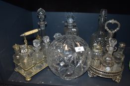 A mixed lot of vintage glass including decanters, condiment sets and more.