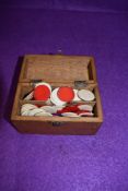 A small box of vintage tiddly winks.