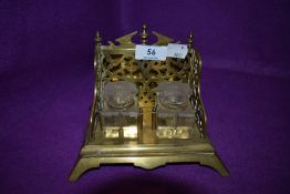 An antique brass and glass desk top ink well set with tray and integrated letter rack.