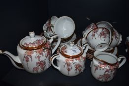 A mid century oriental part tea service having cherry blossom and gilt detailed pattern included are