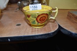 An antique tea cup of small size having hand decoration with mustard yellow glaze and London style