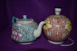 A Charlotte Rhead for Bursley ware tea pot having blue and white ground with pink chrysanthemum like