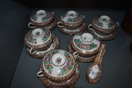 A set of six oriental bowls with lids,saucers and spoons.