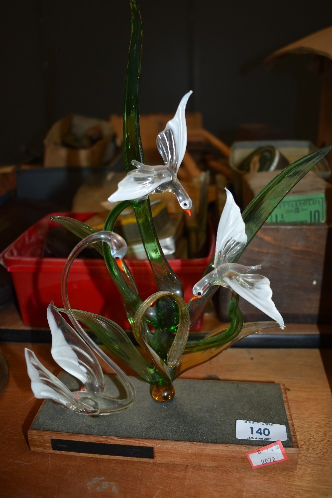 A delicate glass display piece depiciting swans and birds.