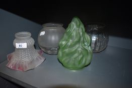 Four vintage glass lamp shades including unusually shaped green shade and fluted shade with pink