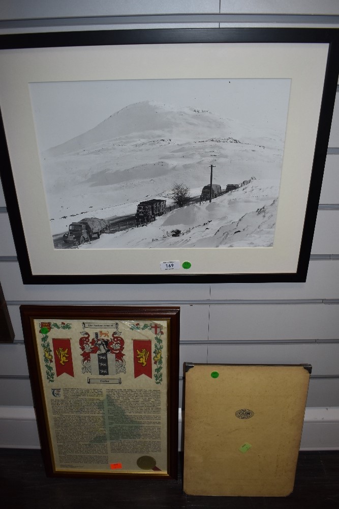 A vintage frame, a framed photograph of a convoy of vintage trucks and similar.