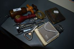 A collection of vintage cork screws,a Ronson lighter in box and a a cigarette case.